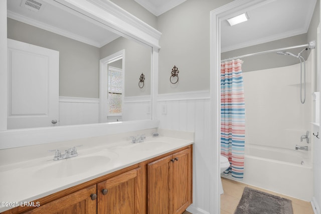 full bathroom with a sink, visible vents, toilet, and wainscoting