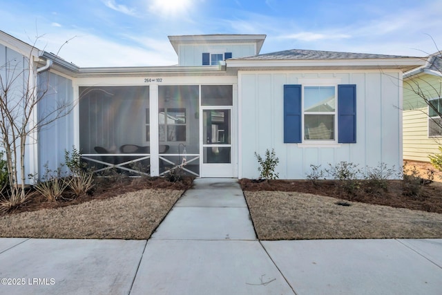 view of front of home featuring a sunroom