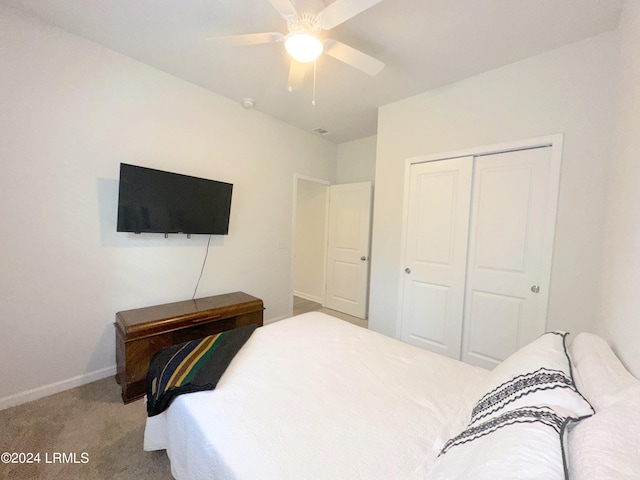 carpeted bedroom with ceiling fan and a closet