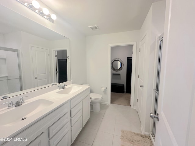 bathroom with walk in shower, vanity, toilet, and tile patterned flooring