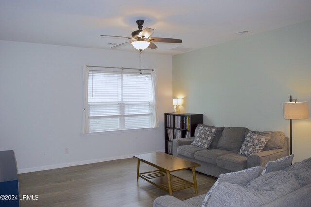 living room featuring wood-type flooring and ceiling fan