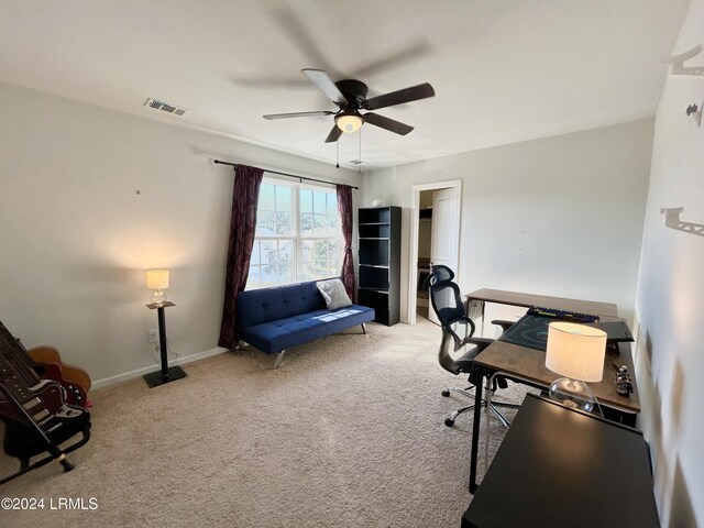 office space featuring ceiling fan and light carpet