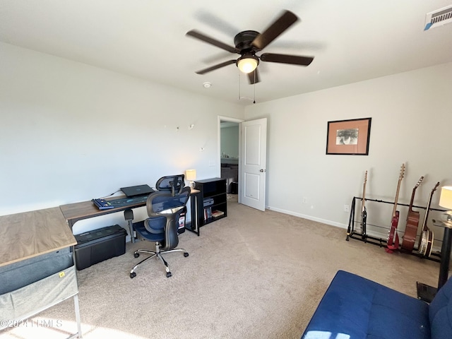 carpeted home office featuring ceiling fan