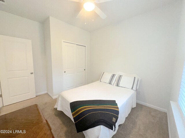 carpeted bedroom with a closet and ceiling fan