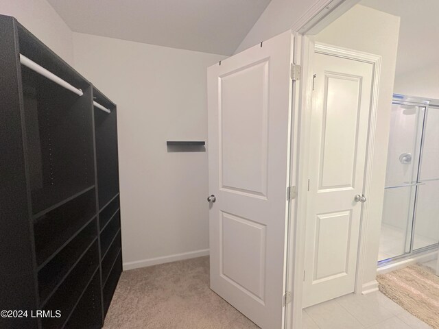 walk in closet featuring light carpet