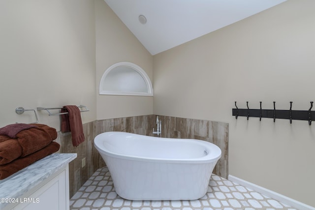 bathroom featuring lofted ceiling and a bathing tub