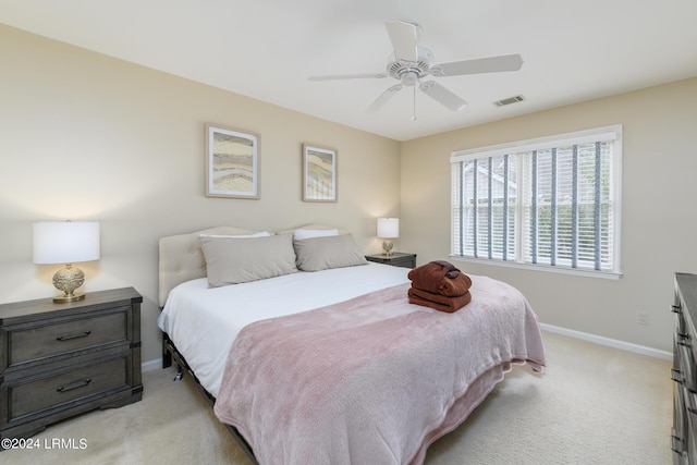 bedroom featuring light colored carpet and ceiling fan