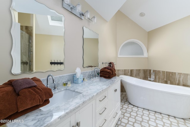 bathroom featuring vaulted ceiling, vanity, and plus walk in shower