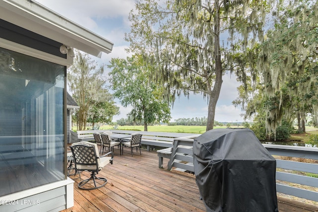 wooden terrace featuring a grill