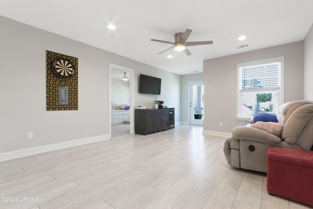 living room featuring ceiling fan and light wood-type flooring