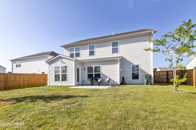 rear view of house with a patio area and a lawn