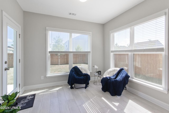 sitting room featuring a healthy amount of sunlight and light wood-type flooring