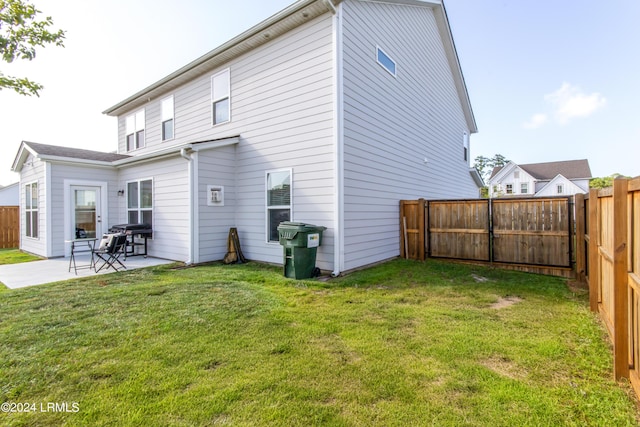 back of property featuring a yard and a patio area