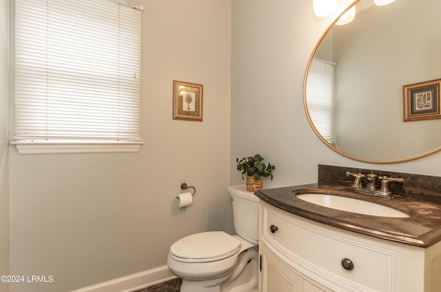 bathroom featuring vanity, toilet, and a wealth of natural light