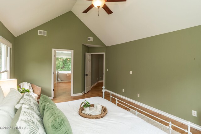 bedroom with multiple windows, wood-type flooring, and ceiling fan