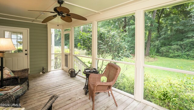 sunroom / solarium featuring ceiling fan