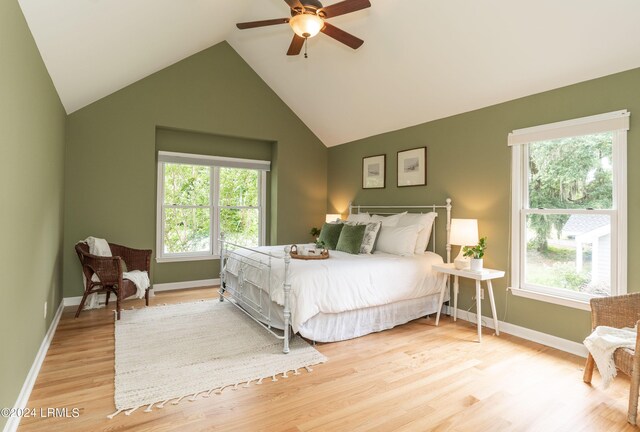 bedroom with vaulted ceiling, light wood-type flooring, and ceiling fan