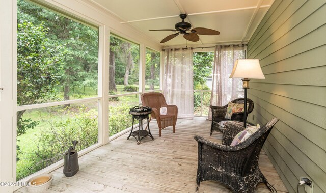 sunroom / solarium featuring ceiling fan and a healthy amount of sunlight