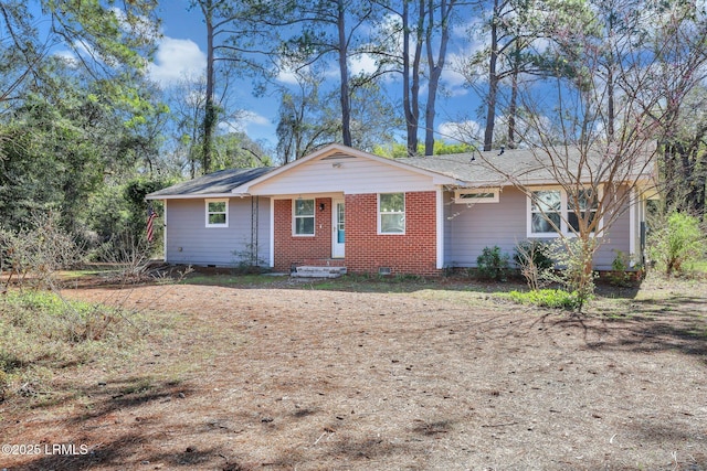 view of front facade featuring brick siding and crawl space