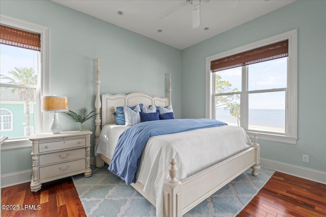 bedroom featuring ceiling fan, wood finished floors, and baseboards