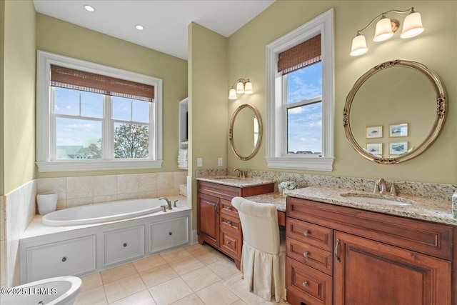 bathroom featuring recessed lighting, tile patterned flooring, a bath, and vanity