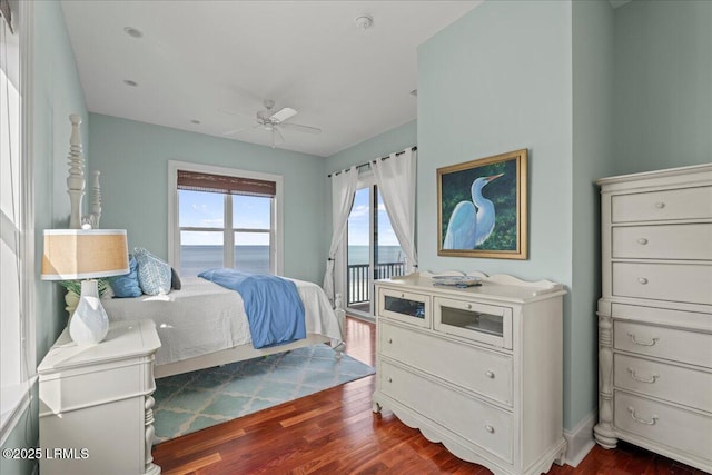 bedroom with dark wood-style floors, access to outside, and ceiling fan