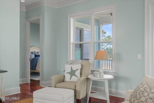 sitting room with ornamental molding, dark wood-type flooring, and baseboards