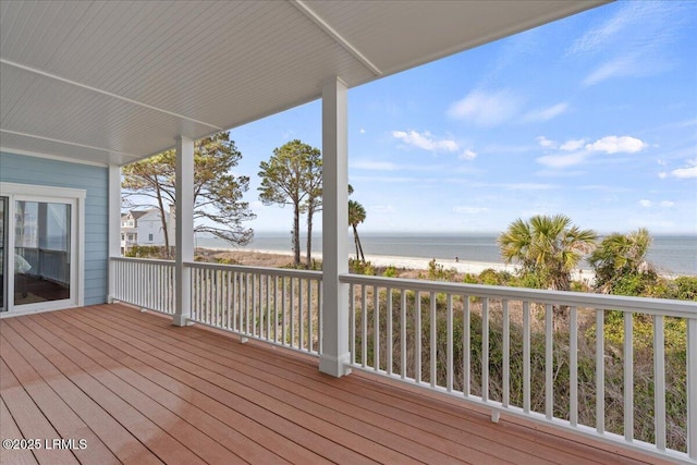 deck featuring a water view and a beach view