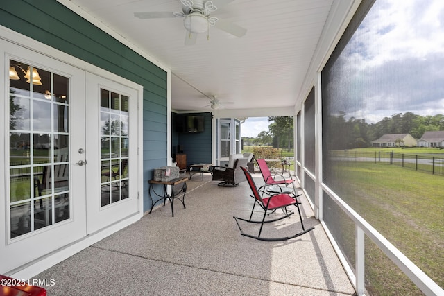 sunroom featuring french doors and ceiling fan