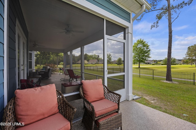 view of patio featuring a sunroom, fence, and ceiling fan