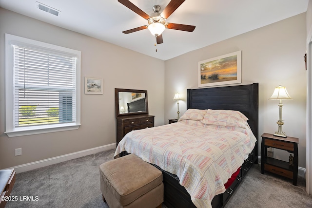 carpeted bedroom featuring baseboards, a ceiling fan, and visible vents