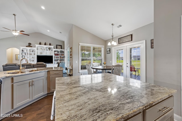 kitchen featuring dark wood-type flooring, a ceiling fan, vaulted ceiling, a sink, and french doors