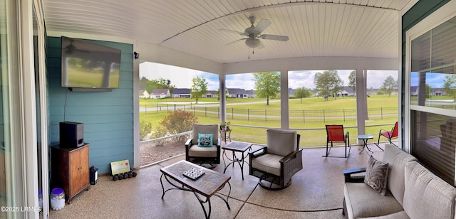 sunroom with an outdoor living space and a ceiling fan