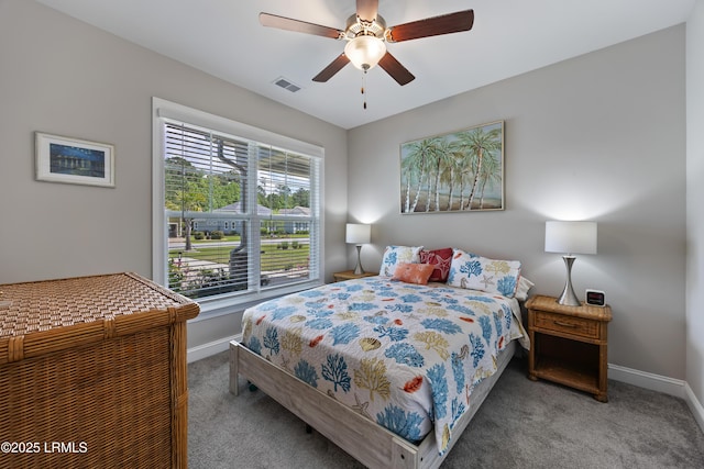 carpeted bedroom with baseboards, a ceiling fan, and visible vents