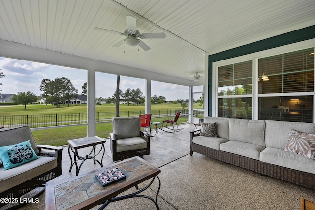 sunroom / solarium with an outdoor living space and ceiling fan
