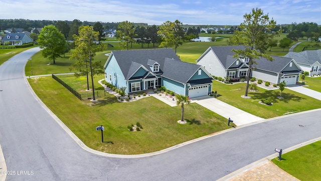 drone / aerial view with a residential view and a water view