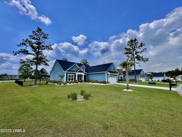 view of front of property with concrete driveway, a front yard, metal roof, and an attached garage