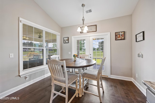 dining room with plenty of natural light, a notable chandelier, visible vents, and vaulted ceiling