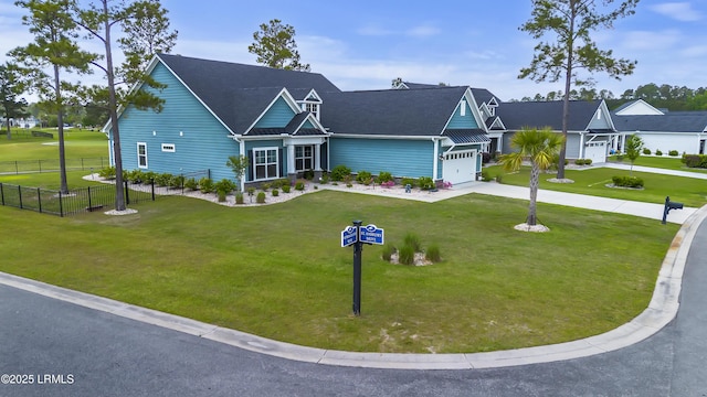 view of front of house with driveway, fence, and a front lawn
