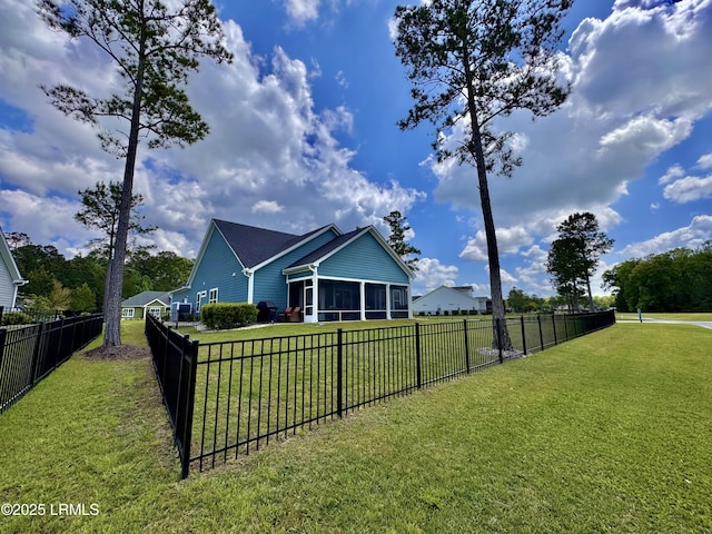 back of house with a yard, a fenced backyard, and a sunroom