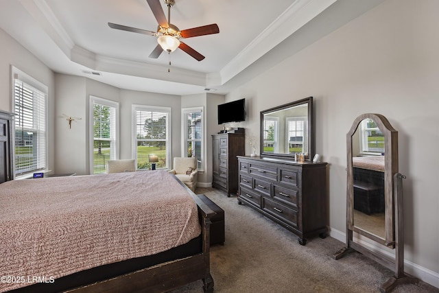 bedroom with carpet, crown molding, and a raised ceiling