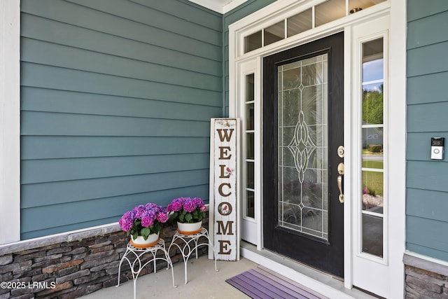 view of exterior entry featuring a porch
