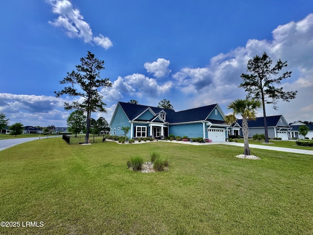 view of front of home with driveway, an attached garage, and a front lawn