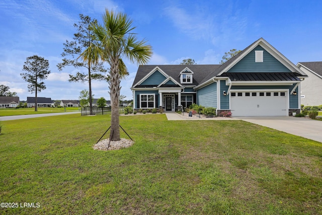 craftsman-style home with a standing seam roof, a front yard, concrete driveway, and a garage