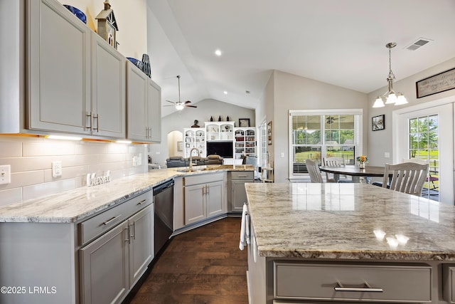 kitchen featuring vaulted ceiling, gray cabinets, dishwasher, ceiling fan with notable chandelier, and a sink