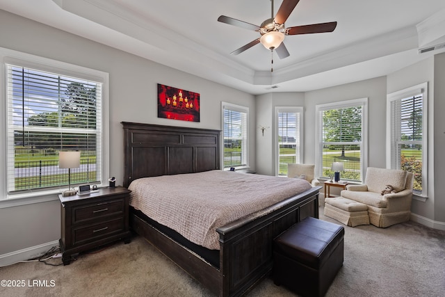 bedroom with crown molding, visible vents, light carpet, a raised ceiling, and baseboards