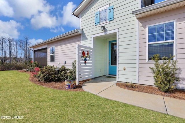 doorway to property featuring a yard