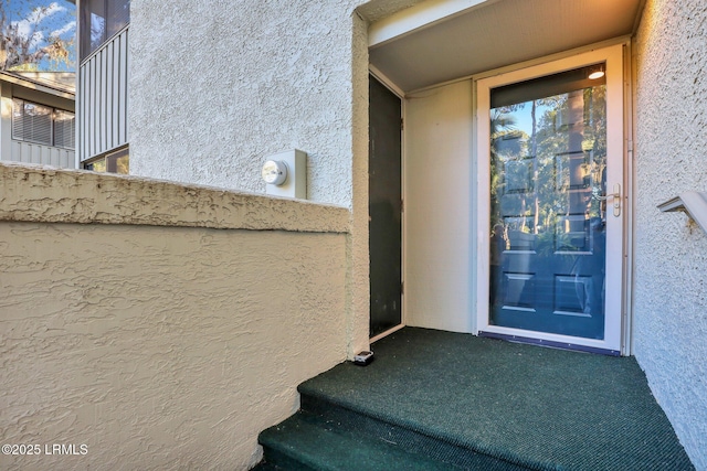 entrance to property featuring a balcony