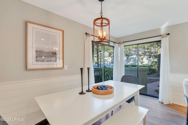 dining area featuring a chandelier and light hardwood / wood-style flooring