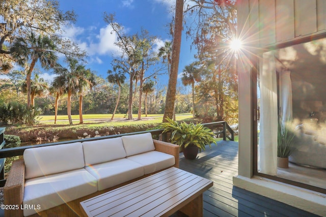 wooden terrace with an outdoor living space